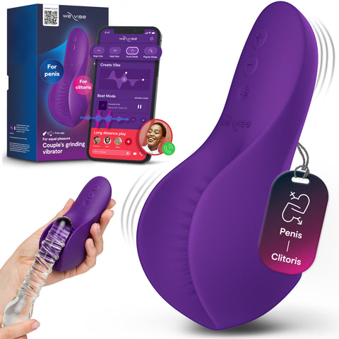 Purple wearable couples' grinding vibrator shown with its retail box, a smartphone app screen, a hand holding the device with a clear flexible sleeve attached, and a hanging tag reading 'Penis Clitoris.' A real hand is visible, so by the priority rules this is Lifestyle rather than Product/Packaging, even though the main focus is still the product.